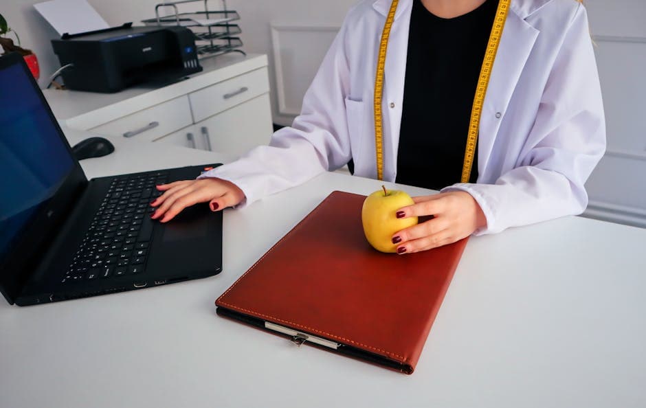 Person researching peptide protocols on a laptop in a bright modern workspace