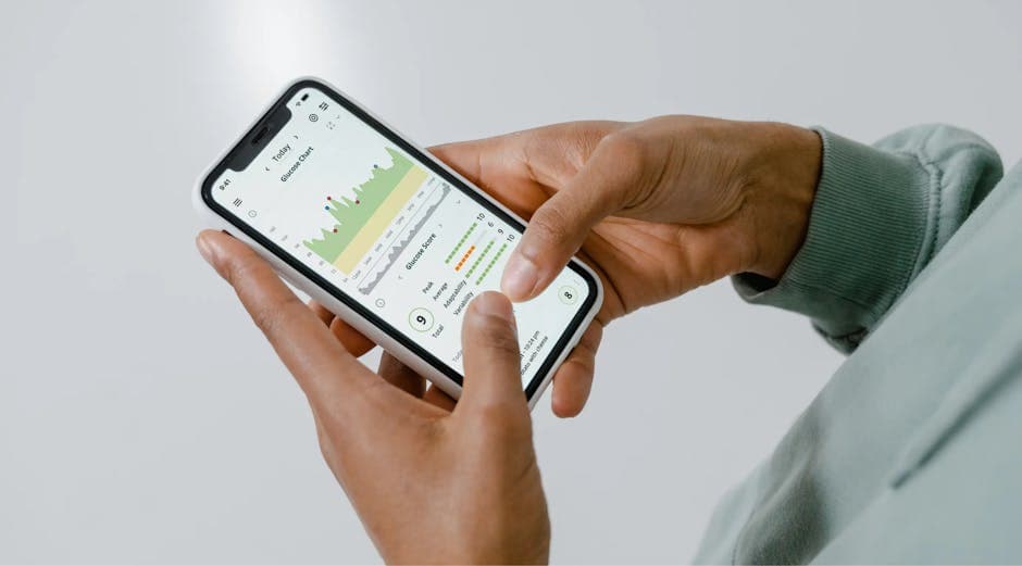 Person reviewing health tracking data on a smartphone app
