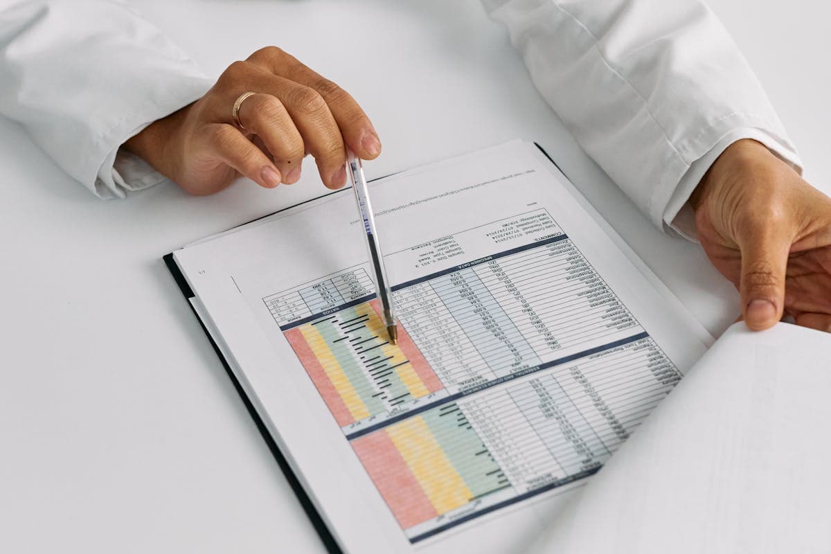 A person reviewing health data on a tablet, with charts and trend lines visible on the screen